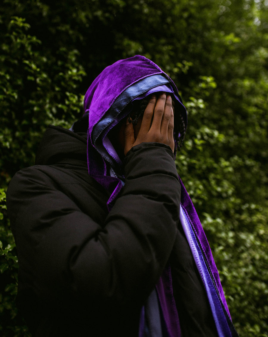 purple durag on top of 2 other durags with boy covering face